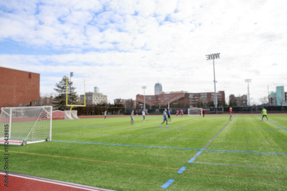 Students playing soccer on the field. team athletes training. blurred background due to the concept. empty space for your text