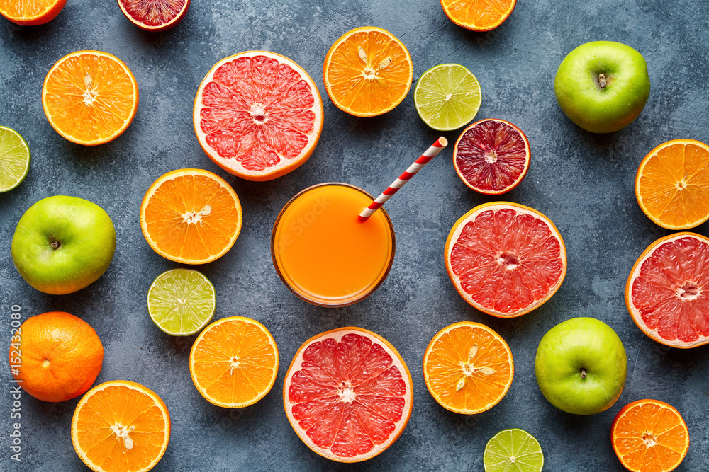 Smoothie or fresh juice vitamin drink in sliced citrus fruits background flat lay Smoothie or fresh juice vitamin drink in sliced citrus fruits background flat lay