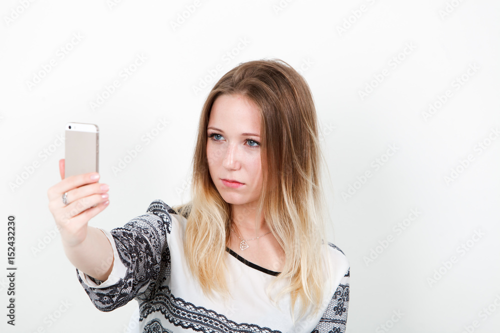 Girl office worker doing selfie at work. On a white background. Girl office worker doing selfie at work. On a white background.