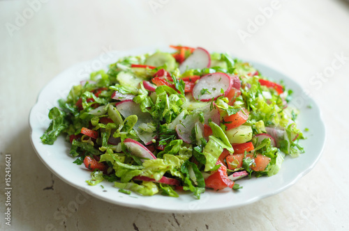 Spring vegan salad with tomato, cucumbers, radish and chinese cabbage