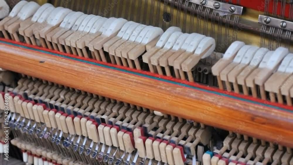 close up shot of the inner workings of a grand piano. The hammers strike the strings as the shot slowly zooms out. HD close up shot of the inner workings of a grand piano. The hammers strike the strings as the shot slowly zooms out. HD