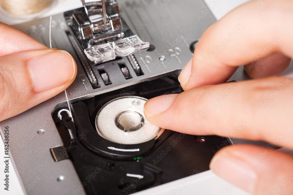 Fototapeta premium put the thread spool in the sewing machine