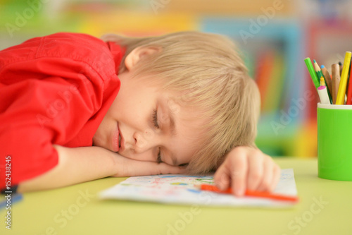 Cute boy drawing with pencils