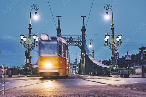 Moving tram on the bridge in the Budapest city early morning