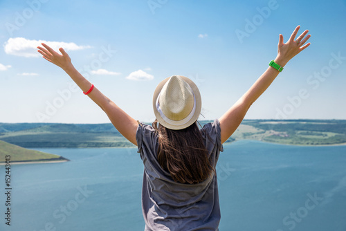 woman raised her arms up on the river bank