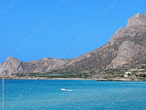Seascape on Crete island, Greece. Lagoon of Falasarna beach with turquoise water and mountains. It is located in Chania region near Kissamos.