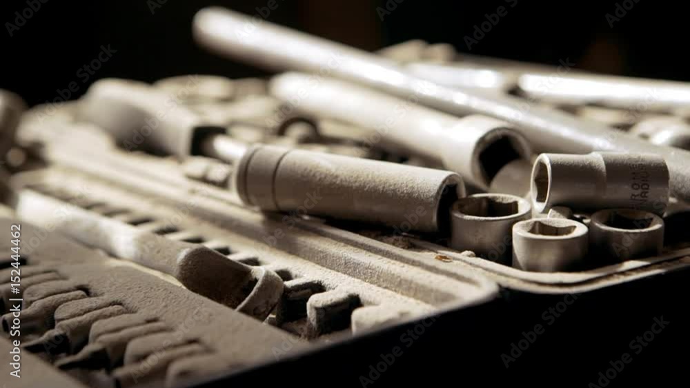 Set of socket wrenchs lying covered with wooden sawdust in joinery. Close up footage in slowmotion Set of socket wrenchs lying covered with wooden sawdust in joinery. Close up footage in slowmotion
