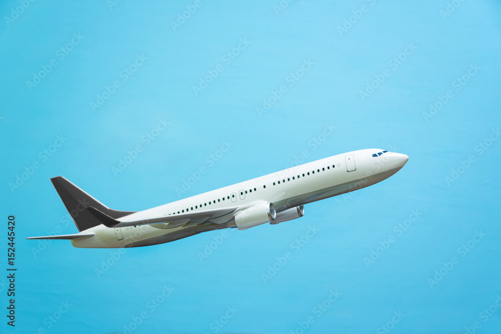 Obraz premium white airplane on a blue background