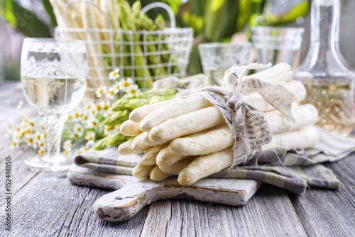 Row green and white Asparagus as close-up on a cutting board