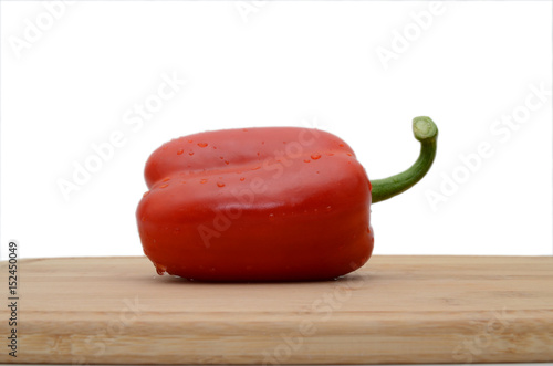 Chopped bell pepers on cutting board wood background