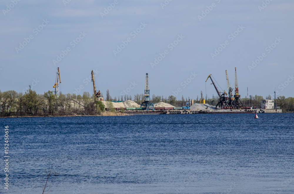 Cranes in cargo port on a river Dnieper in Kremenchug, Ukraine
