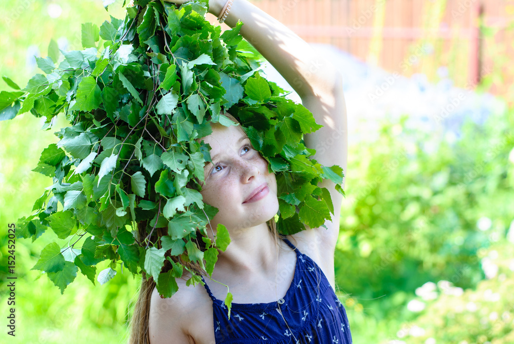 Beautiful little girl with a wreath of green leaves Beautiful little girl with a wreath of green leaves