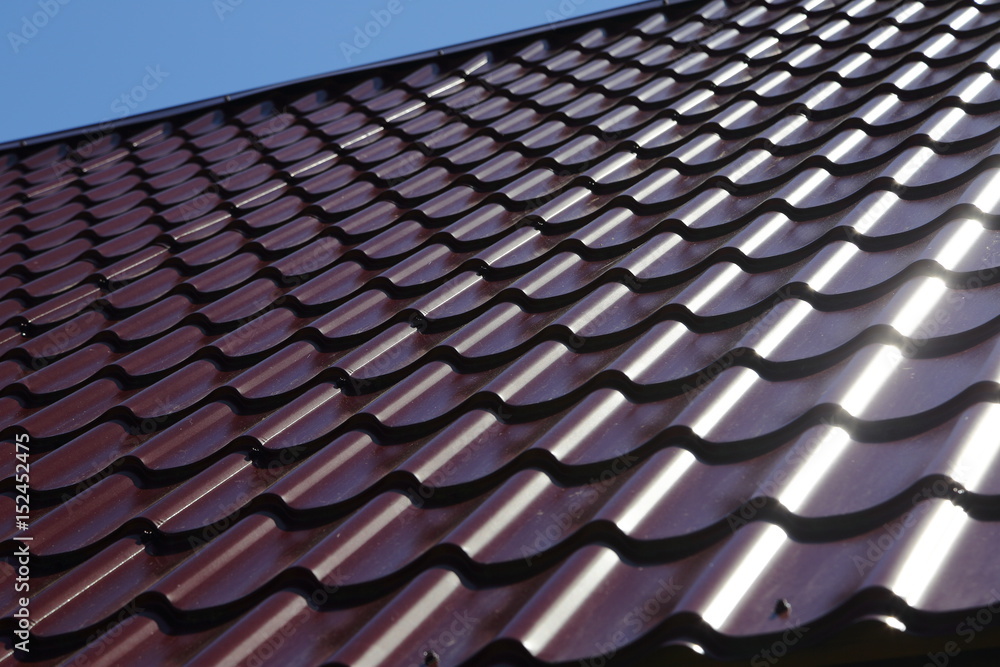 metal shingles on the roof of the house on a Sunny day