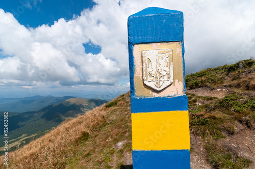 Ukraine border. Frontier in Carpatian mountains, as a symbol of visa-free regime with Europe. Open Ukraine and Europian Union travel concept photo