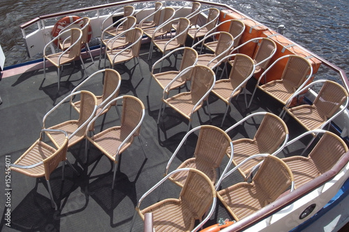 The city is waiting for summer tourists. Water walkable boats  comfortable chairs on deck.