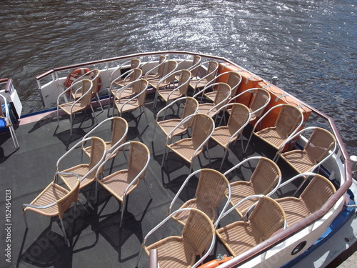 The city is waiting for summer tourists. Water walkable boats, comfortable chairs on deck. photo