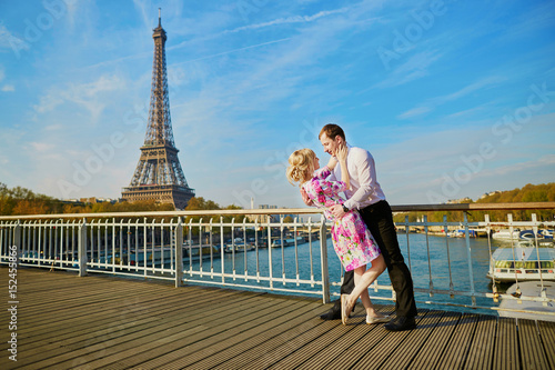 Romantic couple kissing near the Eiffel tower in Paris, France © Ekaterina Pokrovsky