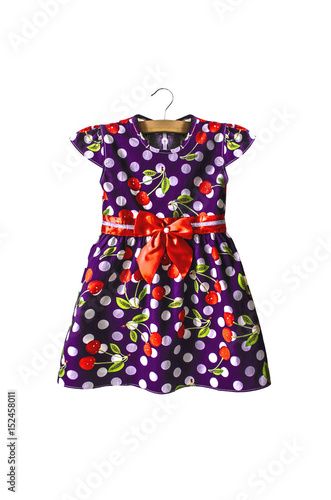 Isolated baby purple summer dress with a pattern of white polka dots and red cherries 