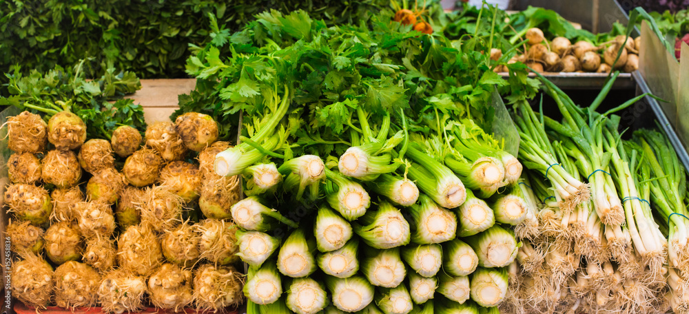 Fresh celery and spring onions in a market Fresh celery and spring onions in a market