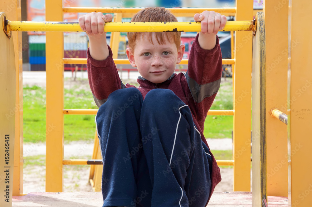 Fototapeta premium child boy playing on the Playground. blurred background.
