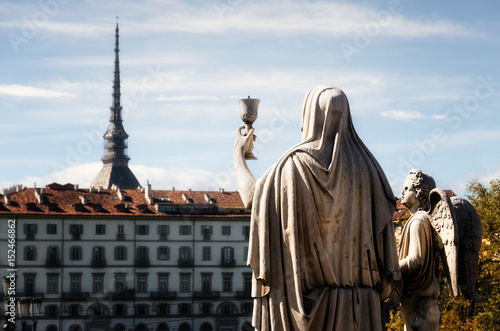 Church of the Gran Madre di Dio in Turin (Piedmont, Italy), detail of the "Faith" sculpture holding a chalice toward the Mole Antonelliana, symbol of the city