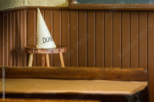Dunce hat in an old school class. photo
