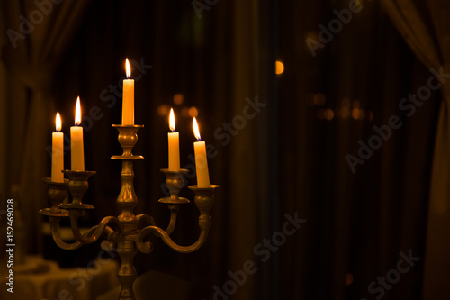 Metal retro candlestick with five burning candles photo