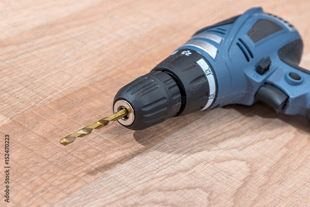 electric drill on wooden desk. close up