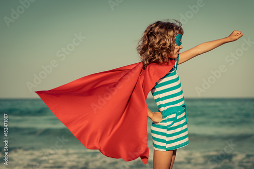 Bild auf Leinwand Superhero child on the beach. Summer vacation concept