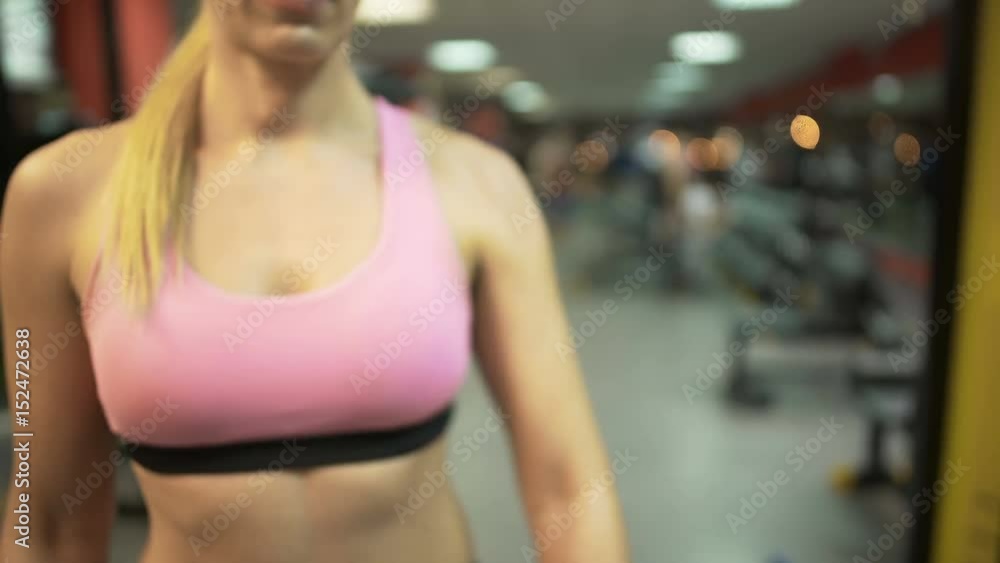 Female setting up smart watch before starting training in gym, fitness app Female setting up smart watch before starting training in gym, fitness app