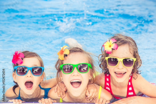 Happy children in the swimming pool © Sunny studio