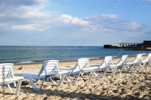  Sunbeds on the beach, a place for sunbathing. Sea summer