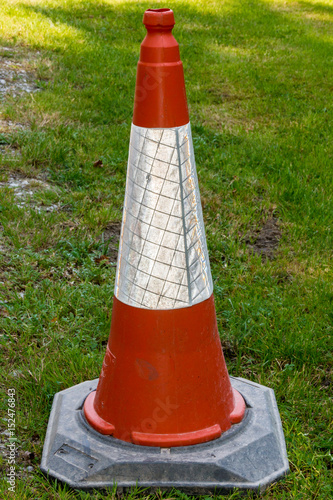 Orange traffic cone with white reflective sleeve