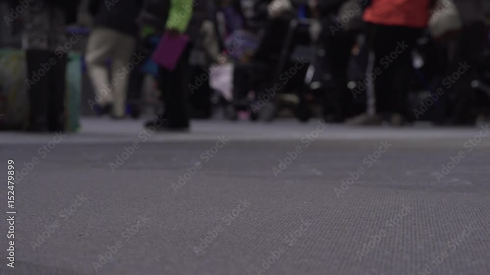 Airport foot traffic with people walking by on carpet.
Airport foot traffic with people walking by on carpet.