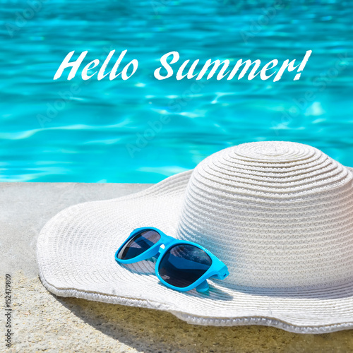 Hello Summer background with hat and sunglasses near the pool