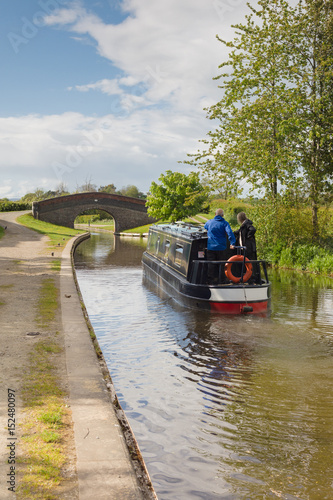 Canal narrowboat navigating the Shropshire Union Canal in England photo