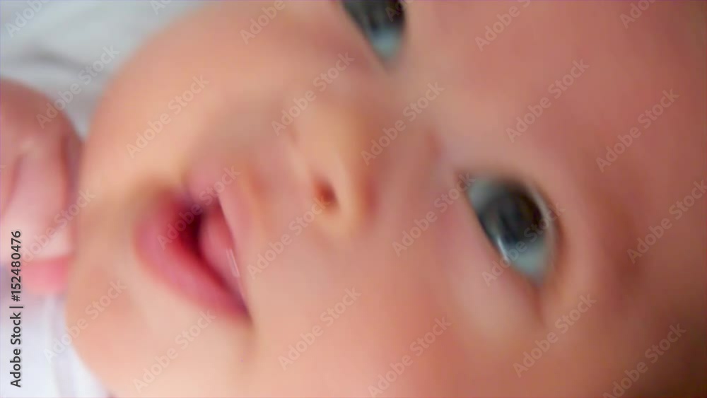 Newborn boy lies in a round bed on his back Newborn boy lies in a round bed on his back