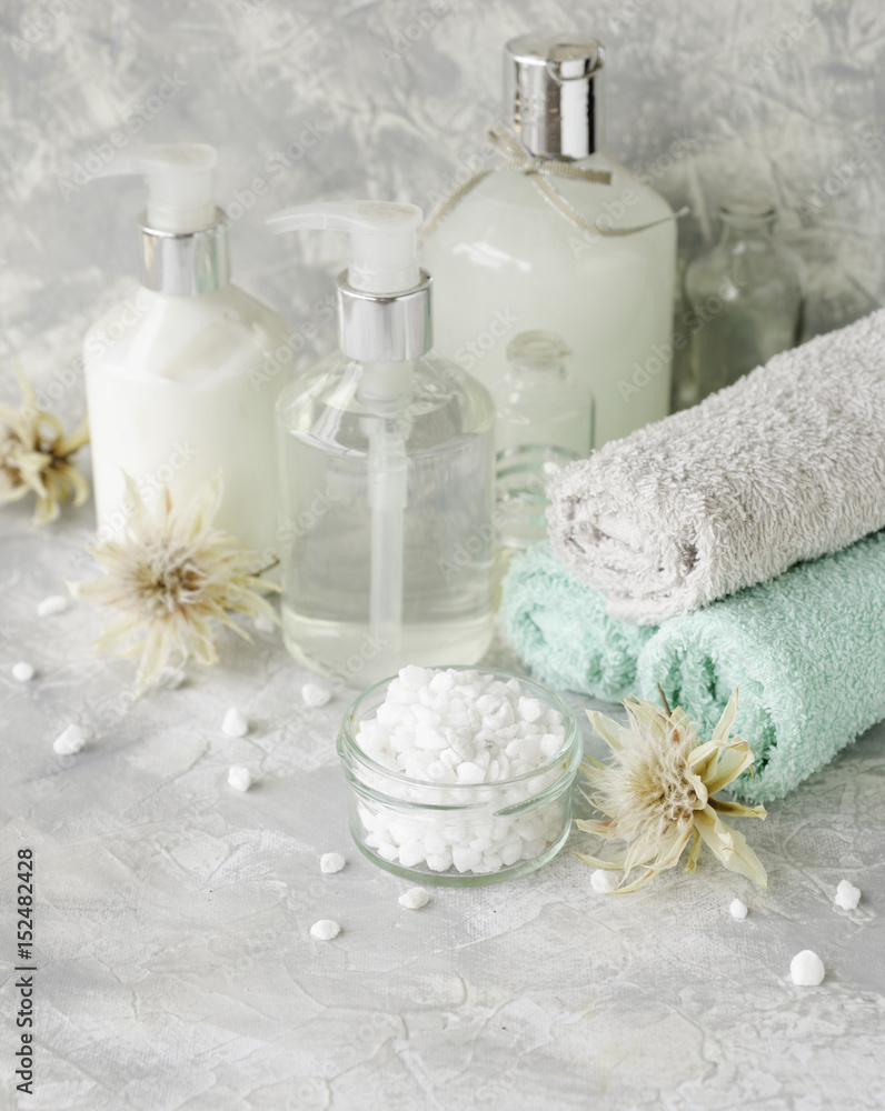 Spa set on a white marble table with a stack of towels, selective focus Spa set on a white marble table with a stack of towels, selective focus