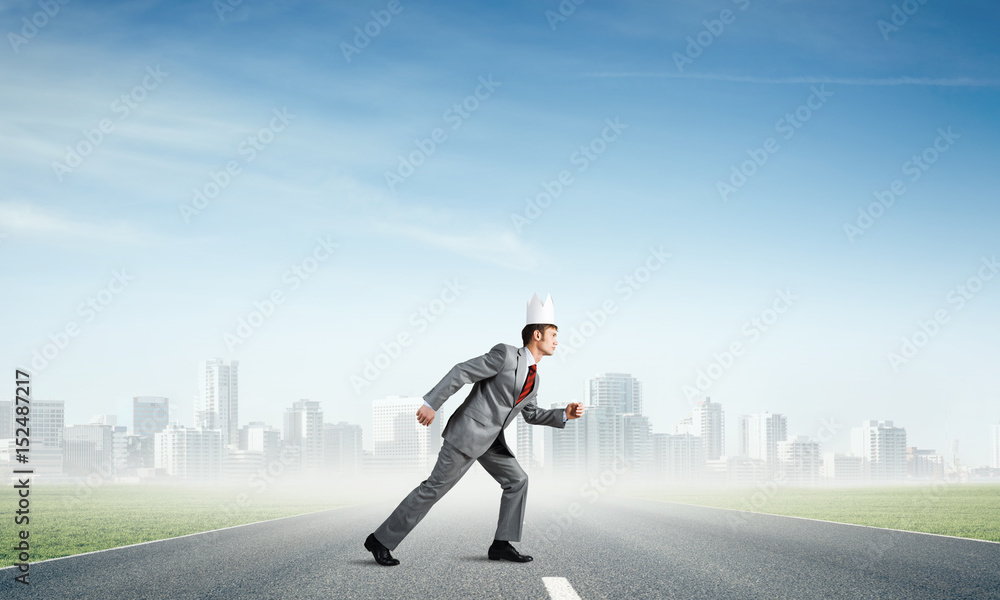 King businessman in elegant suit running and business center at background King businessman in elegant suit running and business center at background
