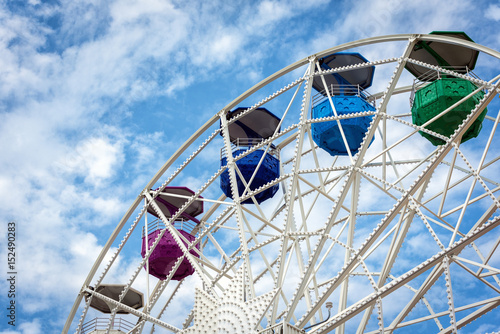 Ferris wheel and cloudy sky at mount Tibidabo in Barcelona, Spain