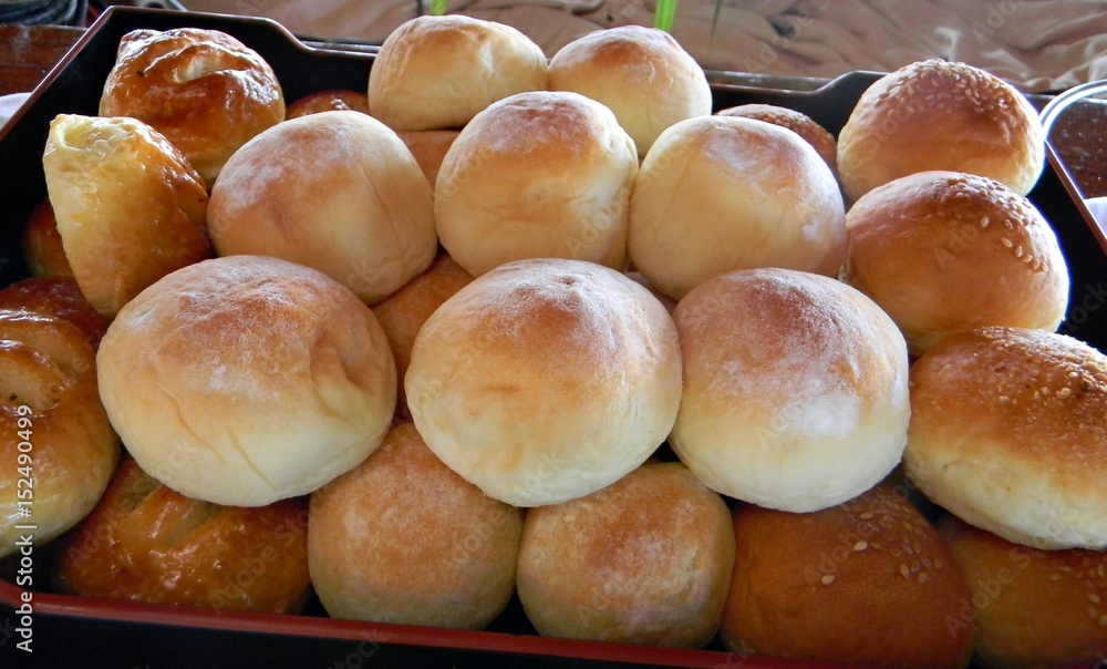 Fresh batch of assorted breads A tray of assorted freshly baked bread provides nourishment for a day.