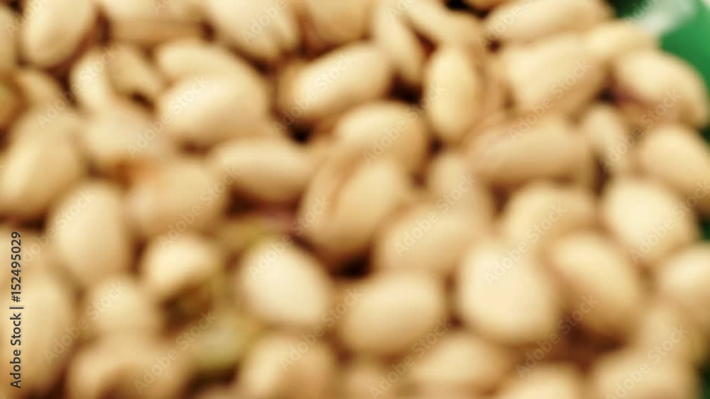 Food background. Roasted pistachio nuts seed with shell close up. Dieting concept. Rack focus 4K ProRes HQ codec Food background. Roasted pistachio nuts seed with shell close up. Dieting concept. Rack focus 4K ProRes HQ codec