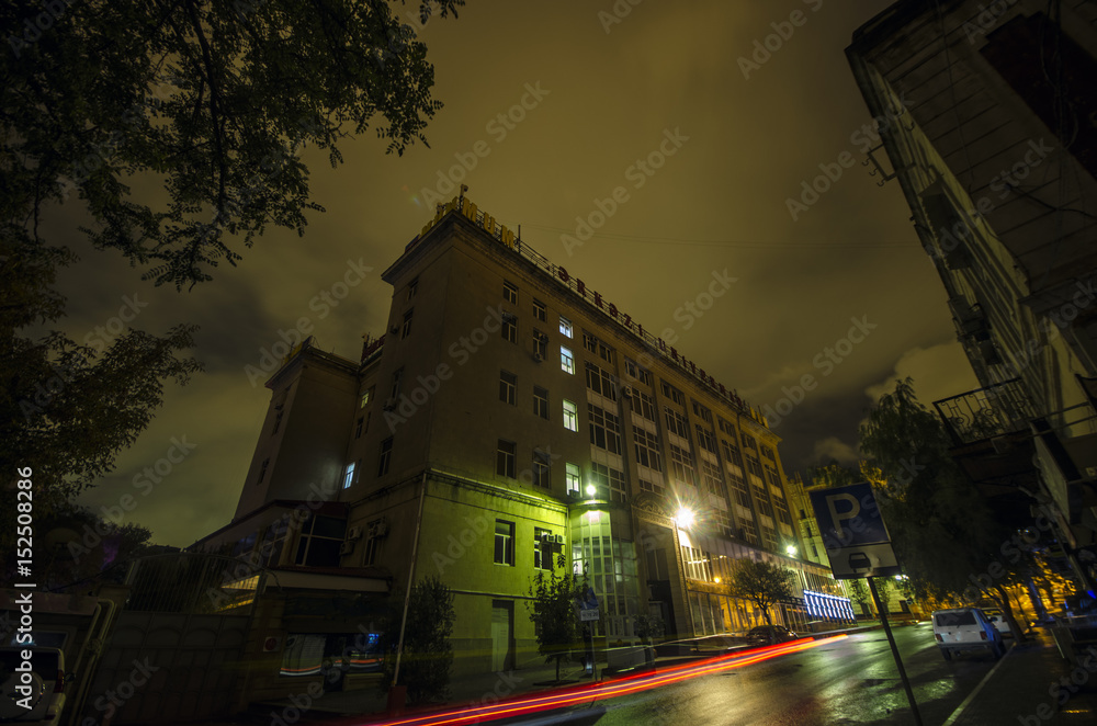 Night view of the city of Baku. Street buildings at night time. Downtown of the capital of Azerbaijan. Autumn time