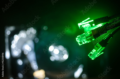 Network switch and ethernet cables  symbol of global communications. Colored network cables on dark background with lights and smoke. Selective focus