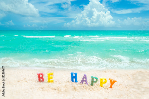 Sign "Be Happy" on the Miami tropical beach