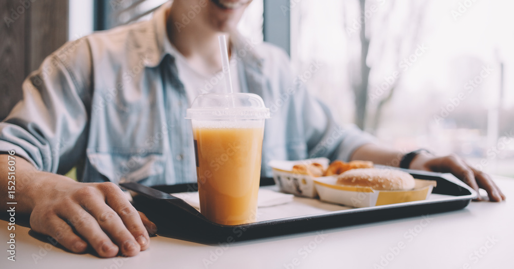 Handsome young man having lunch in cafe alone Handsome young man having lunch in cafe alone