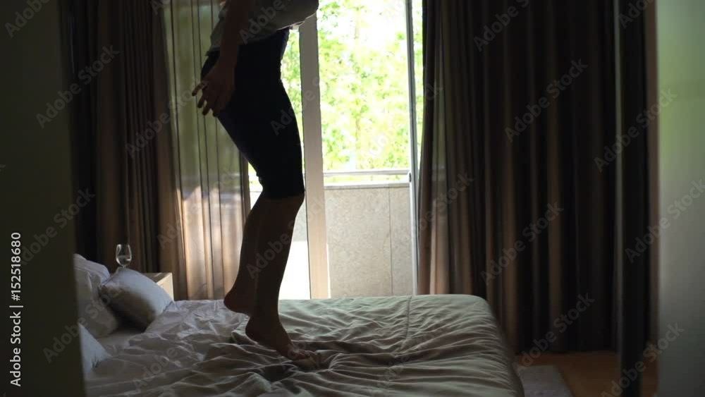 Silhouette of happy woman jumping on bed at home, super slow motion 120fps
Silhouette of happy woman jumping on bed at home, super slow motion 120fps