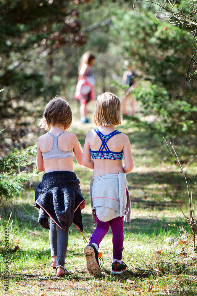 Fototapeta premium Two girls walking on nature trail