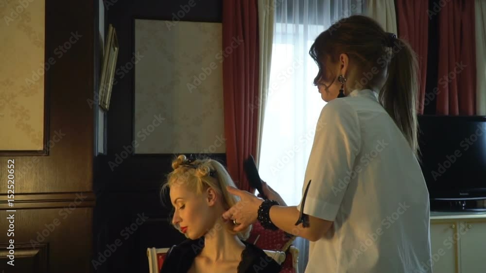 A blonde with beautiful make-up, wears a shiny earring A blonde with beautiful make-up, wears a shiny earring