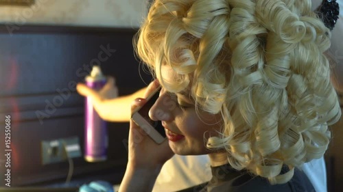 A blonde with beautiful make-up, wears a shiny earring photo